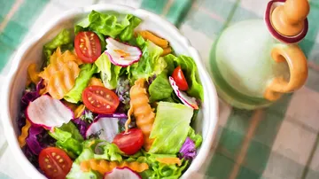 Bowl of colorful salad on a checkered table.