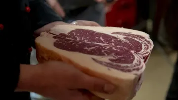 A large piece of meat is kept by one person.