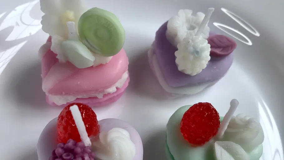 Colourful miniature cakes on a white plate, decorated.