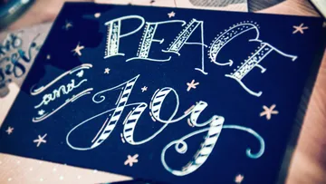 A card with the words 'PEACE and JOY' in decorative lettering.