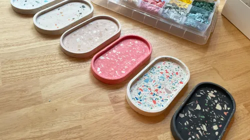 Colourful serving plates are placed on a wooden table.
