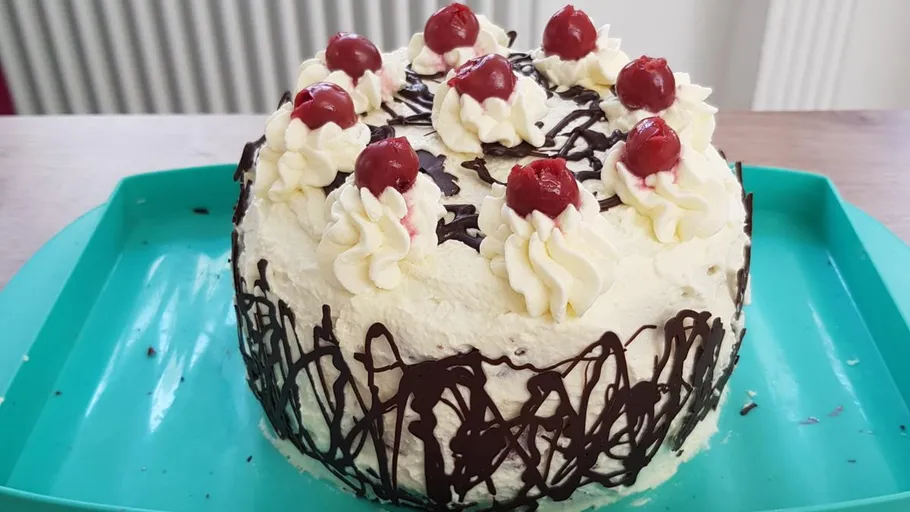 Black Forest cake with cherries on top.