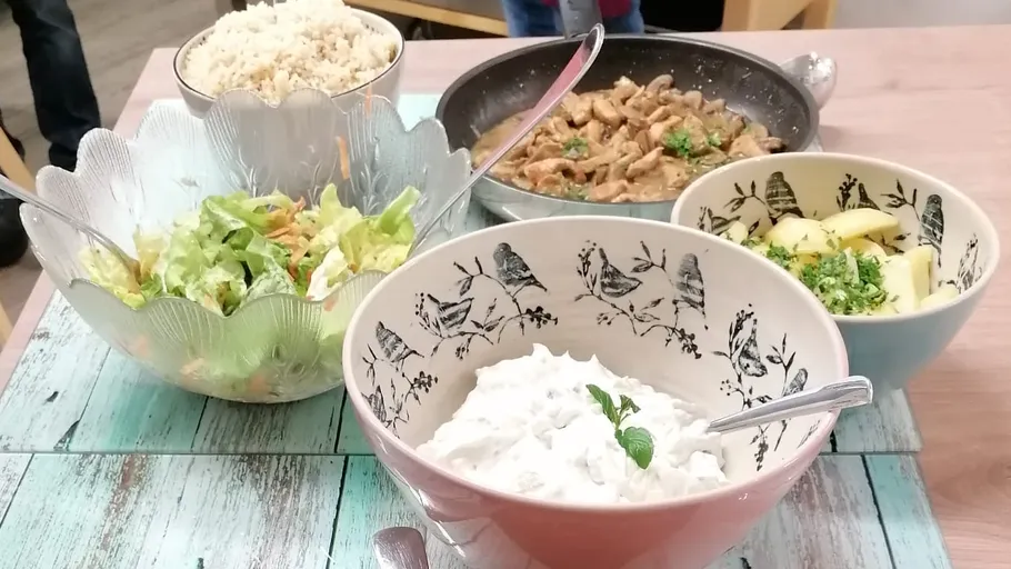 Four bowls with various dishes on a table.