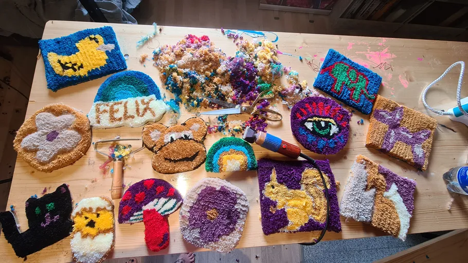 Colourful handicrafts lie on a table, threads scattered around.