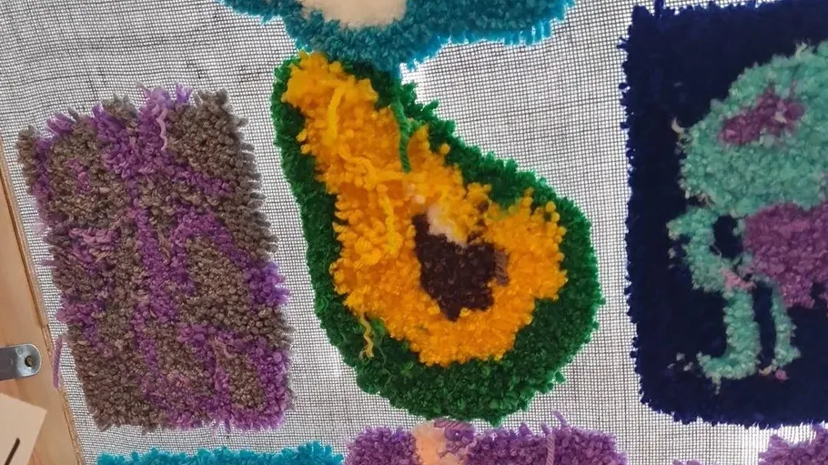 Colorful yarn art resembling a pear shape.