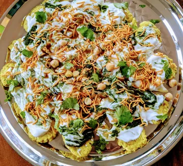 Plate with colorful, garnished snacks and sauces.