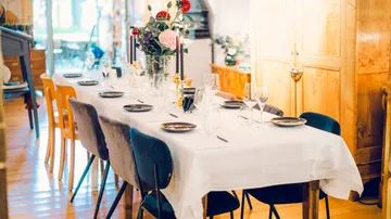 A set table is placed in a bright room.
