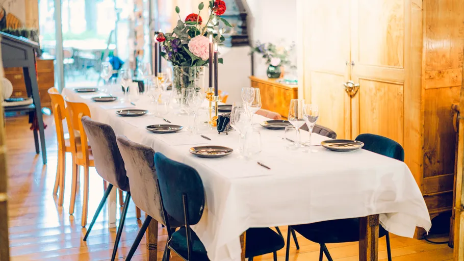A set table is placed in a bright room.