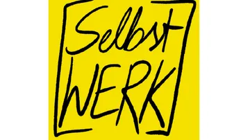 Yellow sign with handwritten text: “Selbstwerk”.
