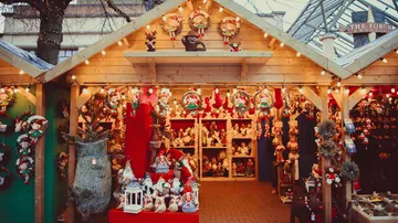 Christmas market stand with festive decorations and lights.