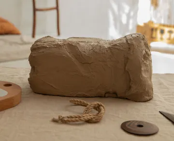 A block of sound is lying on a table in a room.