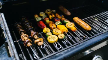 Grilled vegetables and meat on an outdoor grill.