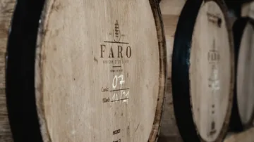 Barrel with whiskey information in a warehouse environment.