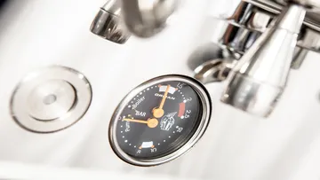 Pressure gauge shows pressure surrounded by stainless steel components.
