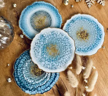 Blue coasters are decorative on a wooden surface.
