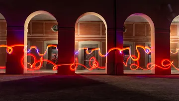 Glowing light flows through an old arcade room.