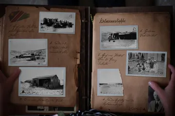 Old photo album with historical pictures and descriptions.