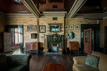 Cosy living room with fireplace and period furniture.