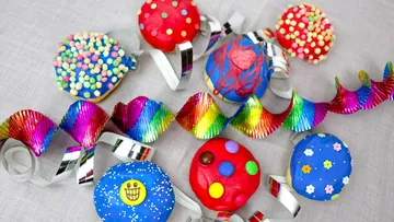 Colourful cookies are decorative on a table surface.