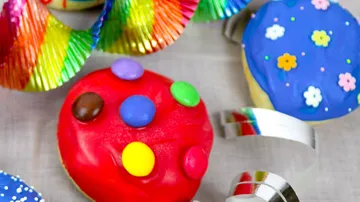 Colourful cookies lie on a table with decoration.