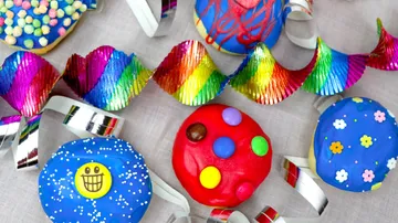 Colourful cookies are decorated on a table with garlands.