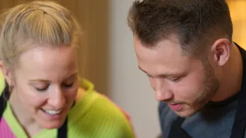 Two people focus on a joint activity.