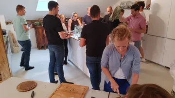 People celebrate with food in a modern, bright kitchen.