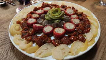 Plate with decorative, filled vegetables on wooden table.