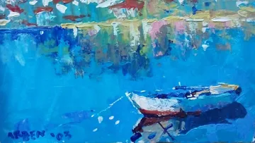 A boat floats on clear, blue water in the background.