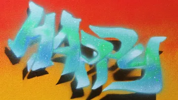 Colourful graffiti inscription “HAPPY” against a gradient background.