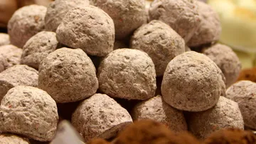 Round, brown balls lie on top of each other on a surface.