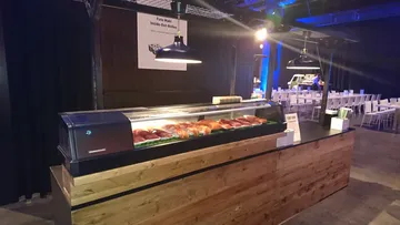 Sushi counter presents colorful sushi rolls in a restaurant.