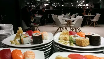 Stacked plates of sushi in an elegant restaurant.