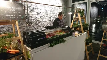 Sushi bar with a chef who makes fresh sushi.