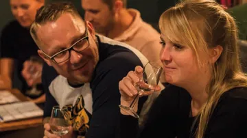 A man and a woman drink in a pleasant conversation.