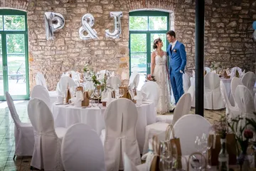 Wedding reception with bridal couple in a festively decorated room.