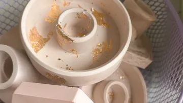 White tableware with gold accents in a basket.