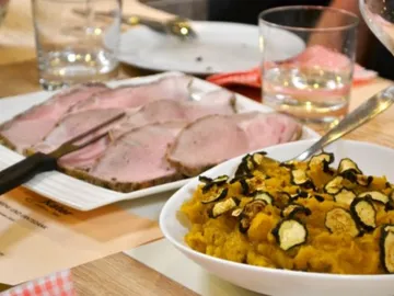 Slice of meat and vegetables served on a table.