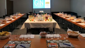Tables decorated with drinks and snacks for an event.