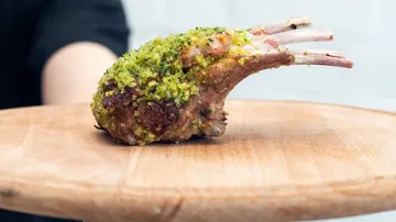 Chop on wooden board, held by hand