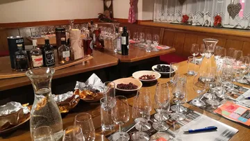 Table with glasses, drinks and snacks in a restaurant.