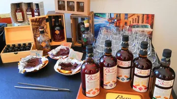 Bottles and glasses stand together on a table.