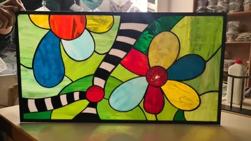 Colorful stained glass art with floral design.