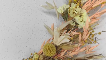 Village dried flower arrangement on light background.