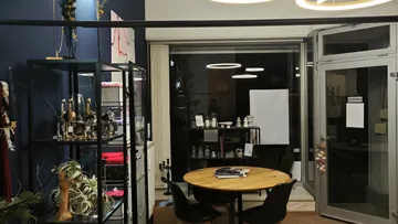 Round table with chairs in a modernly furnished room.