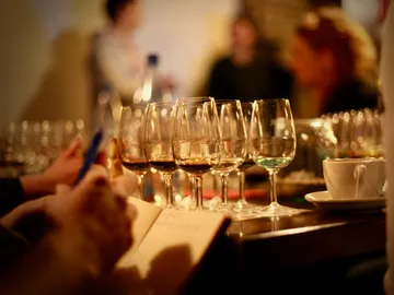 Glasses stand side by side while guests note and taste.