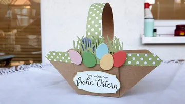 Easter basket with colorful eggs and “Happy Easter” lettering.