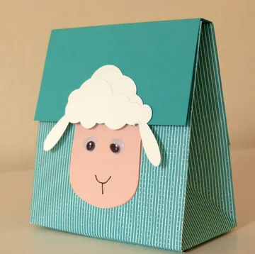 Paper bag with sheep face, smiling, in bright room