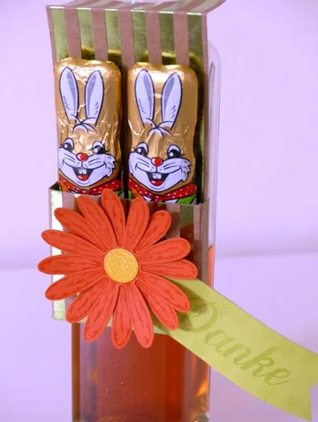 Two chocolate bunnies in colorful gift with flower and thank you.