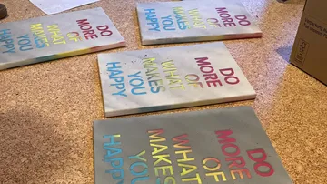 Colourful plates with inspiring sayings lie on the floor.
